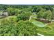 An aerial view of the green golf course surrounded by lush trees, showing beautiful landscaping at 564 Greystone Trce, Marietta, GA 30068