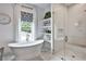 Bright bathroom featuring a freestanding tub, walk-in shower with herringbone tile, and a patterned window shade at 564 Greystone Trce, Marietta, GA 30068