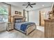 Relaxing bedroom with a blue patterned bedspread, warm lighting, and a doorway to ensuite bathroom at 564 Greystone Trce, Marietta, GA 30068