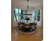 Dining room featuring a round table set, chandelier, and large windows overlooking the surrounding landscape at 564 Greystone Trce, Marietta, GA 30068