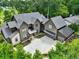 Stunning exterior elevation of a modern home, featuring a spacious driveway, well-manicured landscaping, and a multi-car garage at 564 Greystone Trce, Marietta, GA 30068