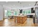 Open kitchen with an island, stainless appliances, black cabinets, and a connected dining area at 564 Greystone Trce, Marietta, GA 30068