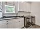 Laundry room featuring a sink, countertop, washer, dryer, upper and lower cabinets, and patterned floor tiles at 564 Greystone Trce, Marietta, GA 30068