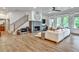 Open-concept living room with fireplace, staircase, and French doors leading to the outdoors at 564 Greystone Trce, Marietta, GA 30068