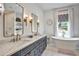Main bathroom with double vanity, freestanding tub, patterned window shade, and lots of natural light at 564 Greystone Trce, Marietta, GA 30068