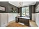 Home office featuring a large desk, wainscotting, dark paint, and a window overlooking the outdoors at 564 Greystone Trce, Marietta, GA 30068