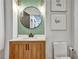 Elegant powder room featuring a round mirror, stylish light fixtures, and a wooden vanity at 564 Greystone Trce, Marietta, GA 30068