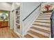 Modern staircase with wooden steps and an iron railing, complemented by a built-in bookcase at 564 Greystone Trce, Marietta, GA 30068