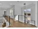 Sophisticated hallway showcasing a modern cable railing and light hardwood floors at 1604 Greendale Rd, Covington, GA 30014