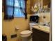 Small bathroom with a toilet, sink, and shower/tub combo at 457 Castleaire Dr, Stone Mountain, GA 30087