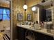 Bathroom with vanity, large mirror, and gold damask wallpaper at 457 Castleaire Dr, Stone Mountain, GA 30087