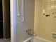 Small bathroom with shower/tub combo and tiled walls at 457 Castleaire Dr, Stone Mountain, GA 30087