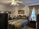 Bedroom with double bed, ceiling fan, and large window at 457 Castleaire Dr, Stone Mountain, GA 30087