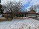 Ranch home with a brown roof, attached garage, and mature tree in front at 457 Castleaire Dr, Stone Mountain, GA 30087