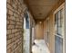 Covered front porch with arched brick entryway and pendant lighting at 457 Castleaire Dr, Stone Mountain, GA 30087