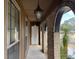Covered front porch with arched brick entryway and pendant lighting at 457 Castleaire Dr, Stone Mountain, GA 30087
