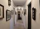 Long hallway with hardwood floors, grandfather clock, and wall art at 457 Castleaire Dr, Stone Mountain, GA 30087