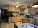 Kitchen with light wood cabinets and black appliances at 457 Castleaire Dr, Stone Mountain, GA 30087