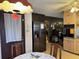 Kitchen with wood cabinets, black appliances and view of dining area at 457 Castleaire Dr, Stone Mountain, GA 30087