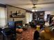 Living room with fireplace, hardwood floors, and a view into kitchen at 457 Castleaire Dr, Stone Mountain, GA 30087