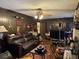 Living room with hardwood floors, a fireplace, and a ceiling fan at 457 Castleaire Dr, Stone Mountain, GA 30087