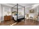Bright bedroom with a four poster bed and hardwood floors at 7535 Cordery Rd, Cumming, GA 30040