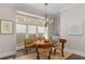 Elegant dining room features a charming chandelier and seating for four at 7535 Cordery Rd, Cumming, GA 30040