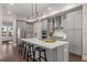 Modern kitchen with gray cabinets, a large island, and stainless steel appliances at 7535 Cordery Rd, Cumming, GA 30040