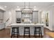 Modern kitchen with gray cabinets, large island, and stainless steel appliances at 7535 Cordery Rd, Cumming, GA 30040
