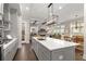 Modern kitchen with gray cabinets, large island, and stainless steel appliances at 7535 Cordery Rd, Cumming, GA 30040