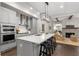 Modern kitchen with gray cabinets, large island, and stainless steel appliances at 7535 Cordery Rd, Cumming, GA 30040