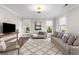 Living room with two sofas, a chaise lounge, and a large TV at 7535 Cordery Rd, Cumming, GA 30040