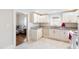 White kitchen with granite countertops and view into living room at 1087 Longley Nw Ave, Atlanta, GA 30318