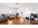 Living room with hardwood floors, sectional sofa, and a view of the kitchen at 1087 Longley Nw Ave, Atlanta, GA 30318