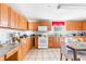 Bright kitchen with light wood cabinets, granite counters, and tile floor at 1091 Longley Nw Ave, Atlanta, GA 30318