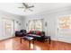 Bright living room with hardwood floors, comfortable seating, and a ceiling fan at 1091 Longley Nw Ave, Atlanta, GA 30318