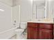 Clean bathroom with a tub, toilet and wood vanity at 6684 Crane Ave, Fairburn, GA 30213