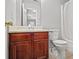 Small bathroom with wood vanity and white toilet at 6684 Crane Ave, Fairburn, GA 30213