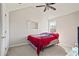 Bedroom with vaulted ceiling, red bedding, and carpet at 6684 Crane Ave, Fairburn, GA 30213