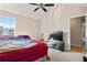 Main bedroom with vaulted ceiling and red bedding at 6684 Crane Ave, Fairburn, GA 30213