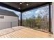 Covered deck with wooden flooring and scenic wooded views at 9165 Golfview Ln, Covington, GA 30014