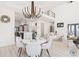 Elegant dining room with a round table and modern chandelier; open to kitchen at 9165 Golfview Ln, Covington, GA 30014