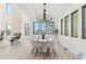 Bright dining room with white table and chairs, and a modern chandelier at 9165 Golfview Ln, Covington, GA 30014