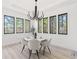 Modern farmhouse dining room with white chairs and a large window at 9165 Golfview Ln, Covington, GA 30014