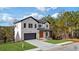 Two-story home with white brick, dark trim, and a wood front door at 9165 Golfview Ln, Covington, GA 30014