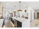 Modern kitchen with large island, stainless steel appliances, and white quartz countertops at 9165 Golfview Ln, Covington, GA 30014