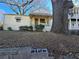 Front view of a yellow house with a porch and large tree at 1140 Ira Sw St, Atlanta, GA 30310