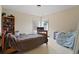 Neutral bedroom featuring two large windows, a bed, and a bookcase at 3130 Caney Creek Ln, Cumming, GA 30041