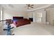 This bright bedroom boasts a tray ceiling, ceiling fan, and french doors at 3130 Caney Creek Ln, Cumming, GA 30041