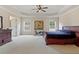 Spacious bedroom featuring neutral carpeting, a ceiling fan, and large windows offering ample natural light at 3130 Caney Creek Ln, Cumming, GA 30041